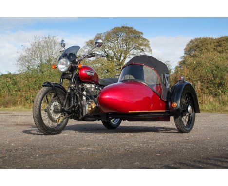 A Triumph Bonneville 800 twin motorcycle and sidecar. FP04 DHE, in red with complete with wet weather hood for sidecar, conve