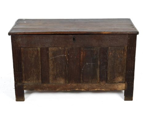 A 19th century carved four panel oak coffer. H73cm x W122cm x D54cm