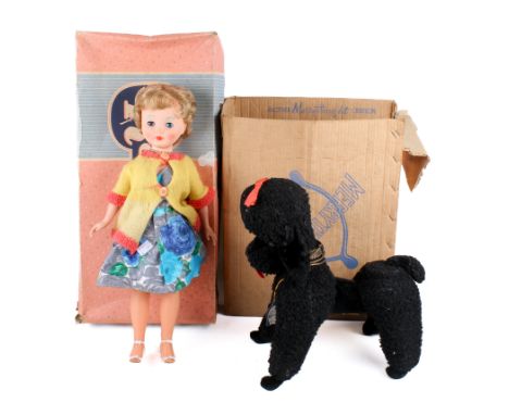 A Merrythought black poodle dog and a boxed Rosebud doll. The dog with red bow and tongue, H35cm, original paper label and bo