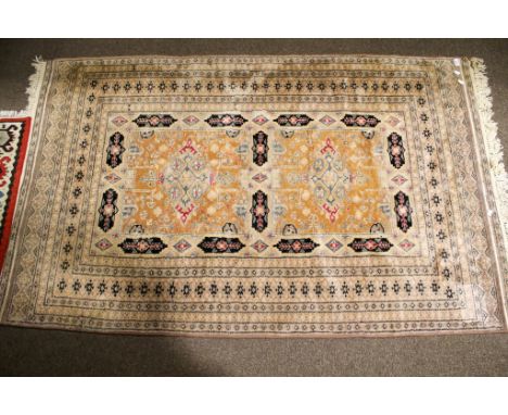 A Persian style woollen rug. Having multiple geometric borders with a pair of square central medallions with light brown grou