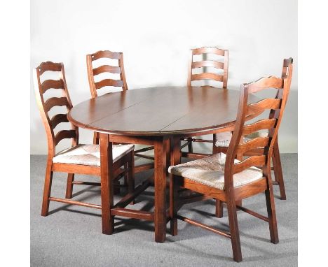 An oak drop leaf dining table, 179cm wide overall, together with a set of eight ladder back rush seated dining chairs (9)179w