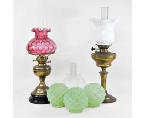 A 19th century brass oil lamp, with an opaline glass shade, 58cm high, together with another, various shades