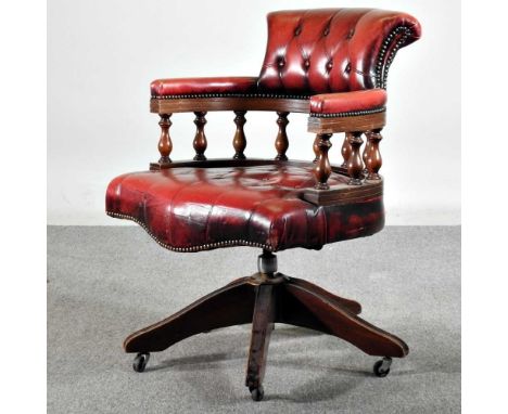A red leather button back desk chairSplits to the seat