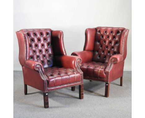 A pair of red upholstered button back armchairs, on square moulded legs (2)