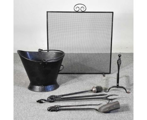 A collection of hand forged fire tools, together with a firescreen, andiron and coal bucket