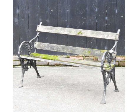 A slatted wooden garden bench, with painted iron supports120w x 58d x 80h cm