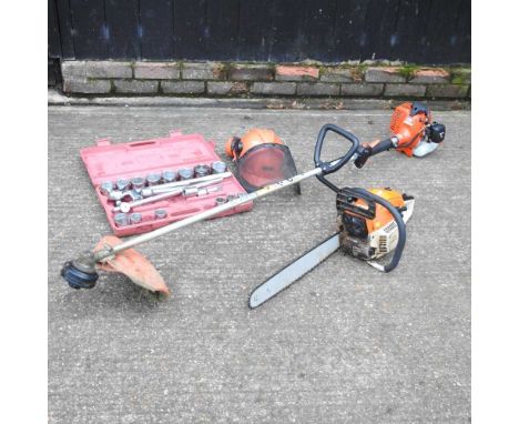 A petrol chainsaw, together with a socket set, a strimmer and a hard hat (4)