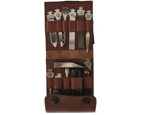 A GOOD RODGERS OF SHEFFIELD FOLDING TOOL KIT, comprising sprung handle and ten supplementary blades and tools, contained in t