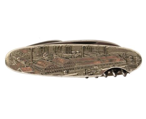 A WHITE METAL MOUNTED GERMAN ADVERTISING PENKNIFE, comprising four various implements mounted between chased white metal scal