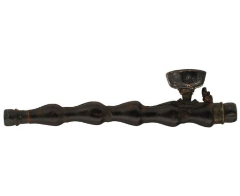 A CHINESE CARVED WOODEN OPIUM PIPE, the lobed wooden body with brass mounts decorated with dragon, the upper face of the bowl