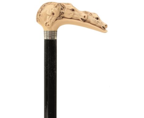 AN EARLY 20TH CENTURY WALKING CANE, the ivory handle carved as three horse's heads, above white metal collar hallmarked Birmi