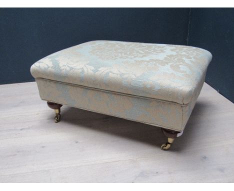 Good quality big armchair and foot stool by Duresta, on turned legs with brass castors, upholstered in cream and light blue f