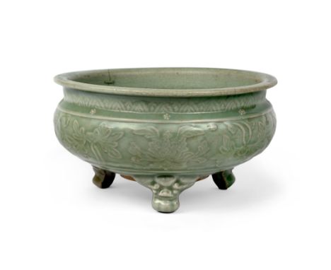 A Chinese Longquan celadon glazed tripod incense burnerMing dynasty, 16th centuryMoulded to the rounded sides with lotus stem