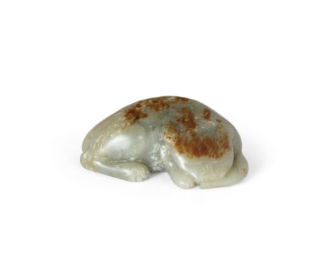 A Chinese green and russet jade carving of a catEarly Qing dynasty, 17th centuryThe recumbent beast carved tormenting a captu
