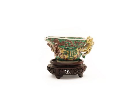 A Chinese famille verte on biscuit libation cupQing dynasty, Kangxi periodPainted with taotie masks and chilong moulded to th