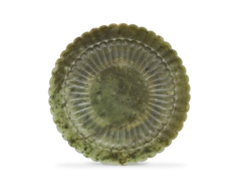 A Mughal-style spinach-green jade 'Chrysanthemum' dishFirst half of 20th centuryStanding on a short, straight foot, carved wi