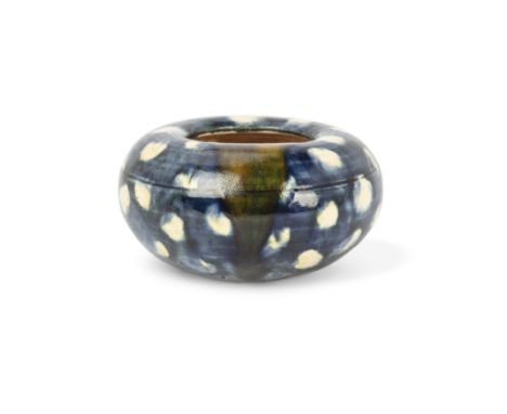 A Chinese blue-glazed water potTang dynastyThe upper body and mouth covered in a bright, white-spotted blue glaze, one yellow
