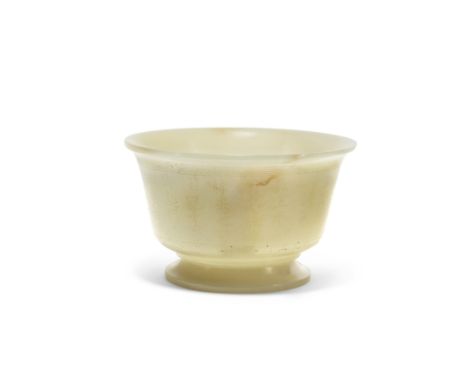A Chinese pale green jade bowl20th century, apocryphal Qianlong markIncised around the exterior with a long poem, 9.6cm diame