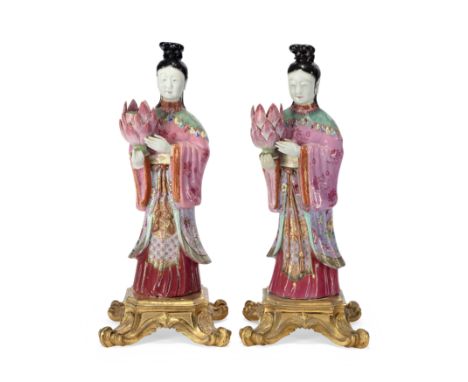 A pair of Chinese famille rose figural candleholdersQing dynasty, Qianlong periodEach modelled as a female immortal holding a