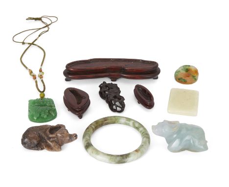 Six Chinese hardstone carvings20th centuryComprising a bangle, three pendant plaques, and two recumbent buffaloes, 4.5cm - 8.