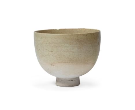 A Chinese straw-glazed pottery cupNorthern/Sui dynastyStanding on a short, tapering foot, the deep vessel covered overall in 