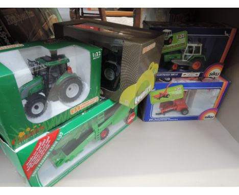 Two Siku die-cast, Fendh Farmer 308LS tractor and a Deutz Corn Forage Harvester, both in window display boxes and two Univers
