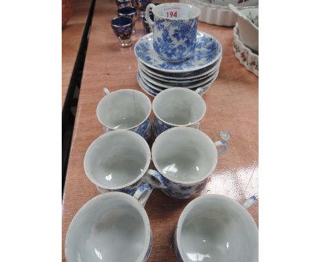 A set of blue and white coffee cups and saucers