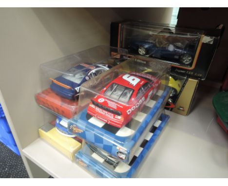 Five 1:24 scale die-cast Nascar Racing, cars, and two Maisto and Burago 1:18 die-cast sports cars, all boxed