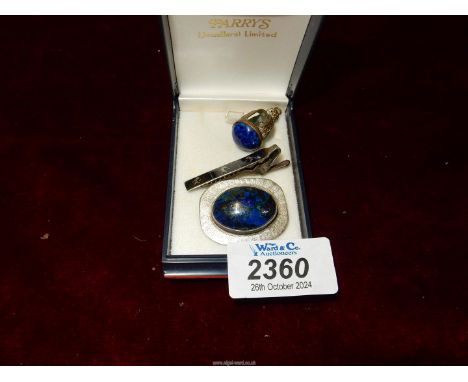 A Sterling silver tie clip, brooch set with oval polished Lapis Lazuli stone and a pendant set with same.