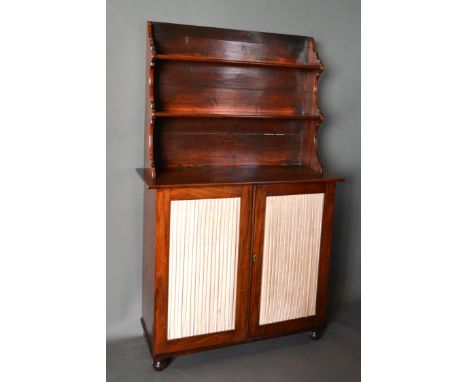 A 19th Century Mahogany Chiffonier, the boarded shelf back above a lower section with two fabric pleated doors, raised upon l