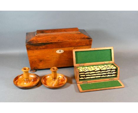 A 19th Century Mahogany Sarcophagus Shaped Tea Caddy, the hinged cover enclosing a fitted interior together with a pair of So