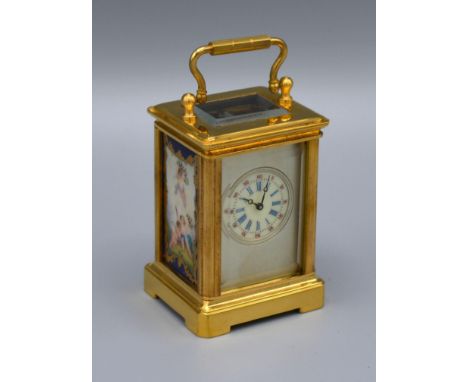 A Brass Cased Carriage Clock, the silvered dial with circular enamel face and with porcelain side panels, lever escapement an
