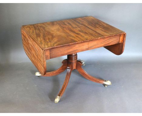 A Regency Mahogany Sofa Table, the two frieze drawers above a turned centre column, outswept legs with brass caps and caster,