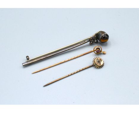 A Yellow Metal Stick Pin set garnet and diamonds together with two other stick pins 