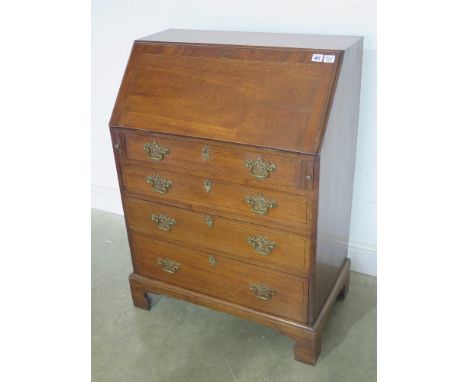 A mahogany four drawer bureau of small proportions with an inlaid interior of drawers and pigeon holes over four graduated dr