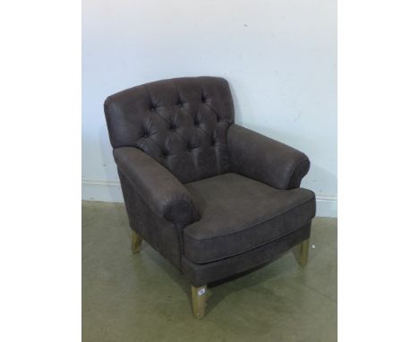 A Libra design button back armchair 