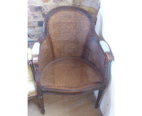 A French style walnut open armchair with cane seat sides and back raised on turned and reeded supports - Height 92 cm x Width