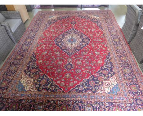 A Royal Kashan carpet, classic oval medallion on red field - 417 cm x 310 cm 