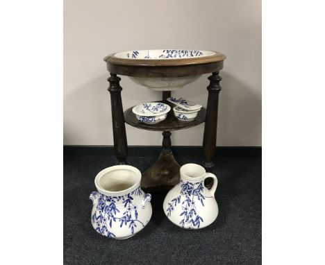 An antique circular mahogany wash stand inset blue and white floral basin and a matching five piece pottery wash set 