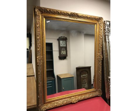 A contemporary gilt overmantel mirror in ornate frame, 100cm by 126cm
