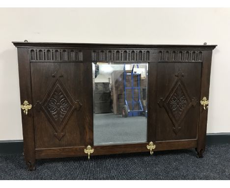 An early 20th century oak mirrored coat rack 