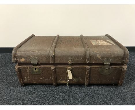 An early 20th century wooden bound travelling trunk 