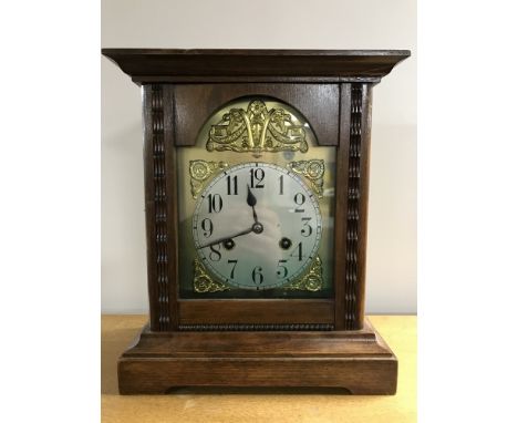 A stained pine cased German mantel clock with brass dial 