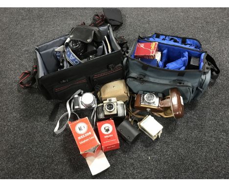 A quantity of camera equipment, lenses, flashes etc 