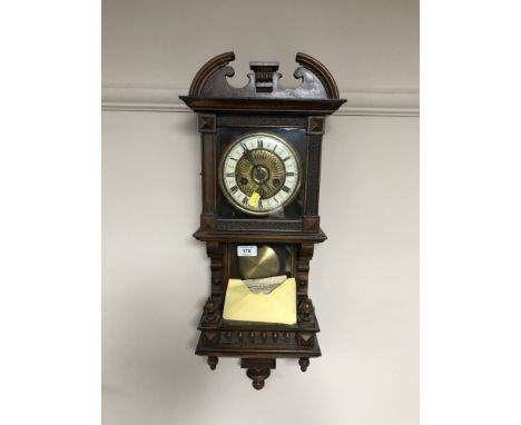 An early 20th century mahogany cased eight day wall clock with pendulum and key 