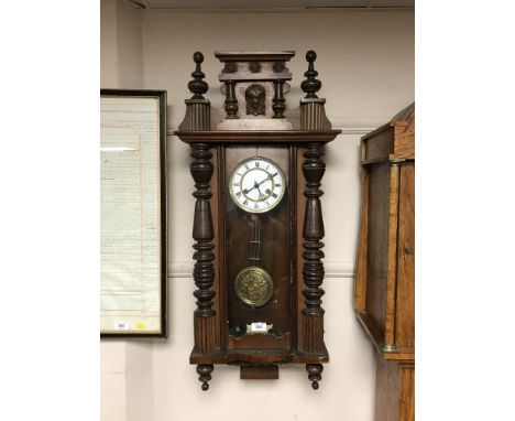 A continental mahogany eight day wall clock with enamel dial