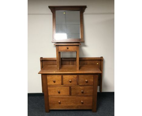 A pine five drawer chest, 4'6 headboard, bedside stand and matching wall mirror 