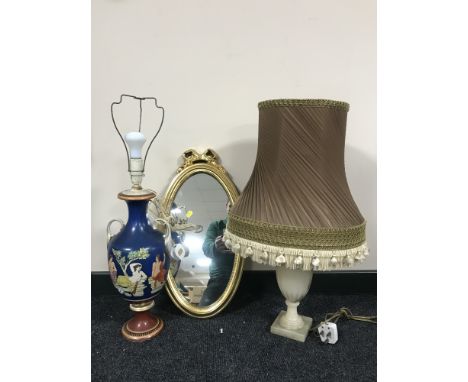 A small oval gilt framed mirror, marble table lamp and shade, china table lamp and shade 