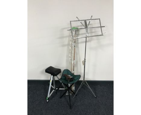 A two piece fly rod, multiplier reel, two folding tripod stools, metal music stand and a Lark chin rest 