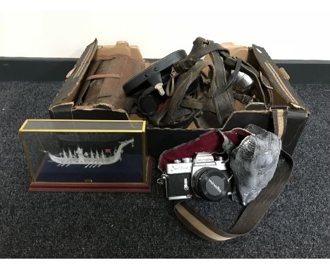 A box of cased galleon, binoculars, Minolta camera with lens, horse tack etc 